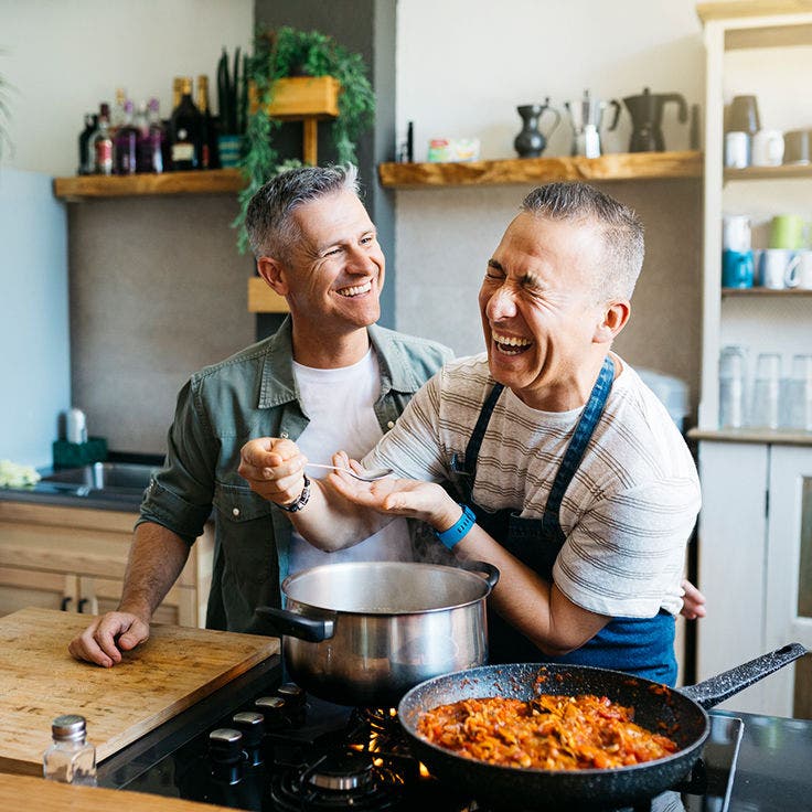 Husbands cooking and laughing