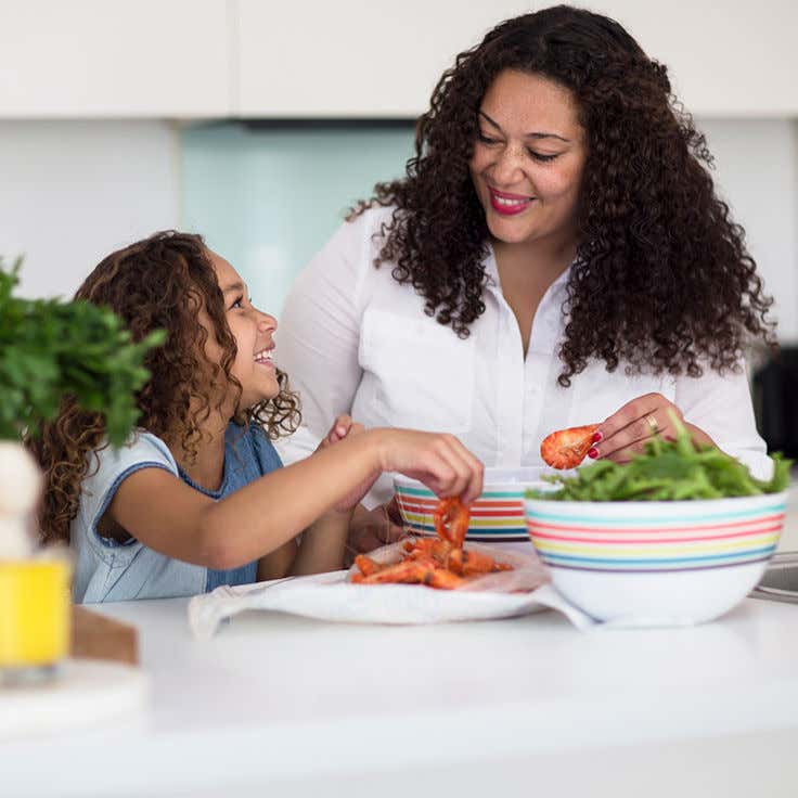 First Nations mum making prawn salad with her young daughter