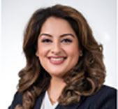 Person with long wavy hair wearing dark blazer
