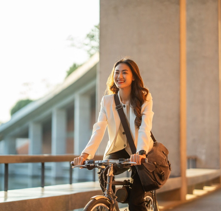 Woman wearing corporate clothing cycling outdoors