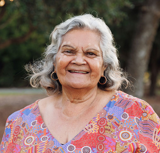 Woman smiling wearing colourful top