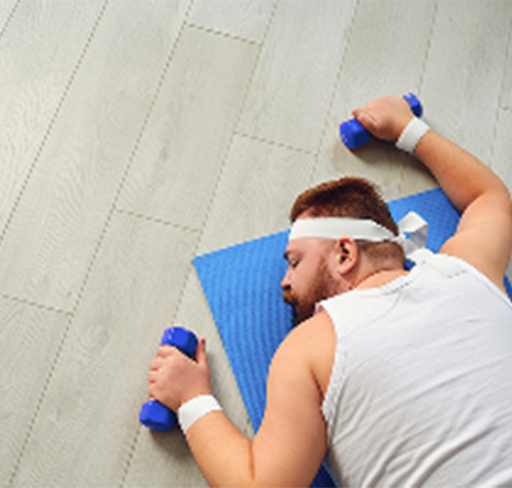 man sleeping in yoga mat with duumbbells in hand