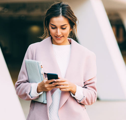 Woman in pink coat looking at her phone