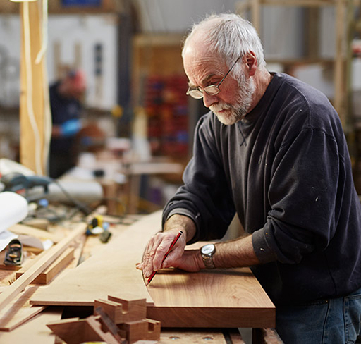 Older man in carpenter workshop