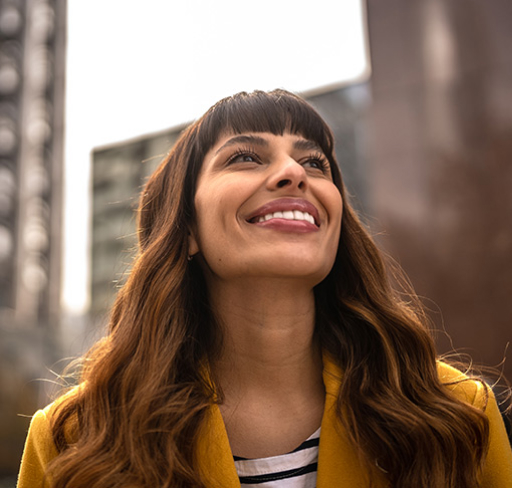 Woman in yellow blazer smiling