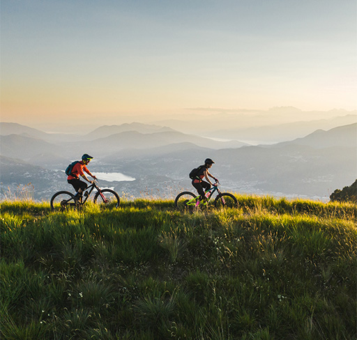 Two cyclists travelling through mountain trails
