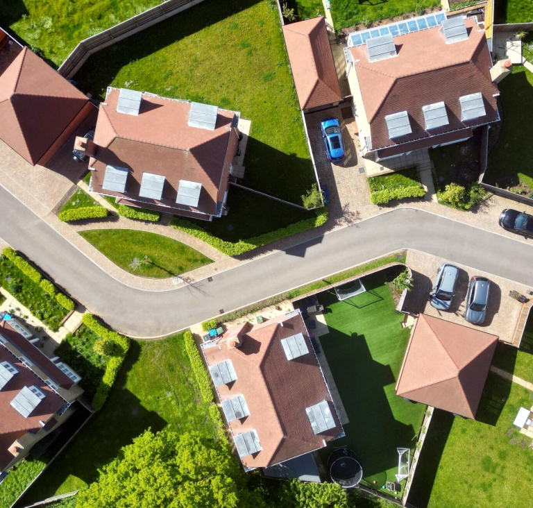 Birds eye view of rooves of houses on a suburban street