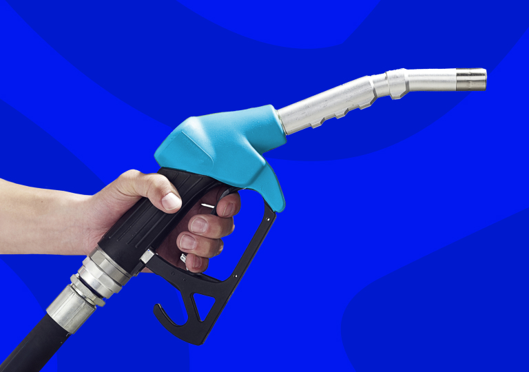 Hand holding a fuel pump nozzle against a blue background