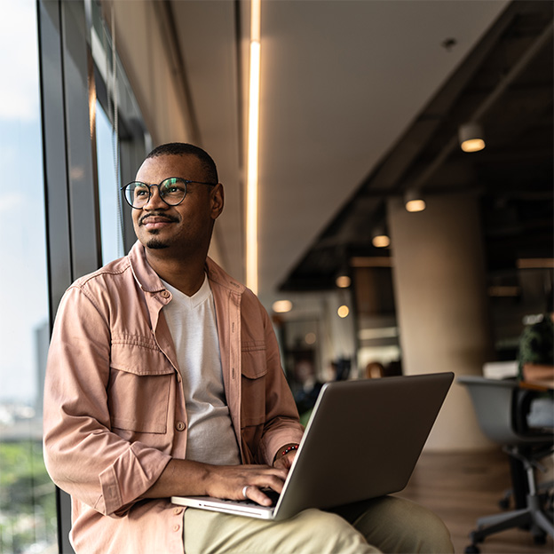 A person watching outside with laptop