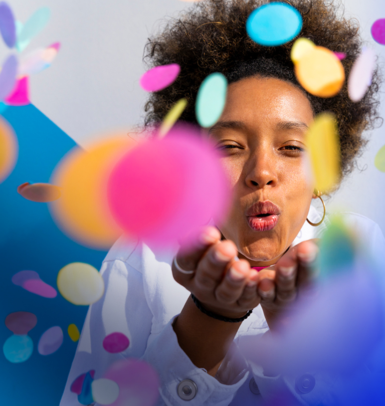 Woman blowing confetti