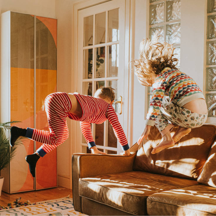 Childrens jumping on sofa