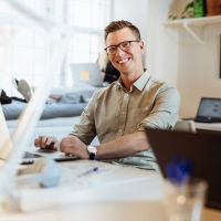 Man typing and smiling