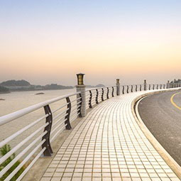 Footpath on curved road with sunset view