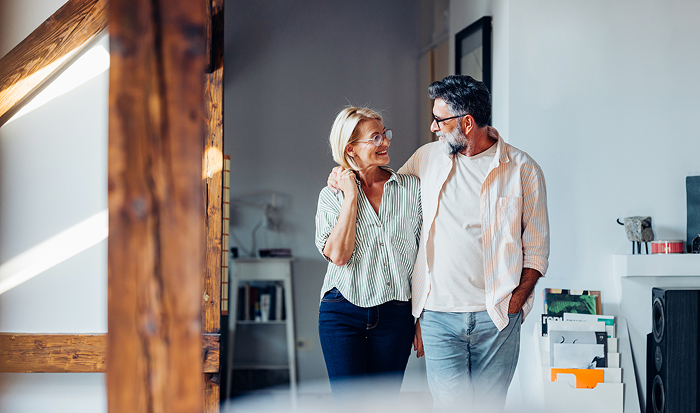 Man walking with arm around woman