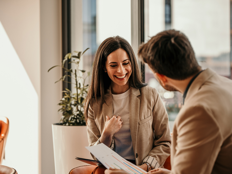 Man and woman discussing papers