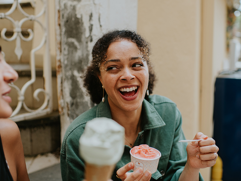 Woman eating ice cream with friend