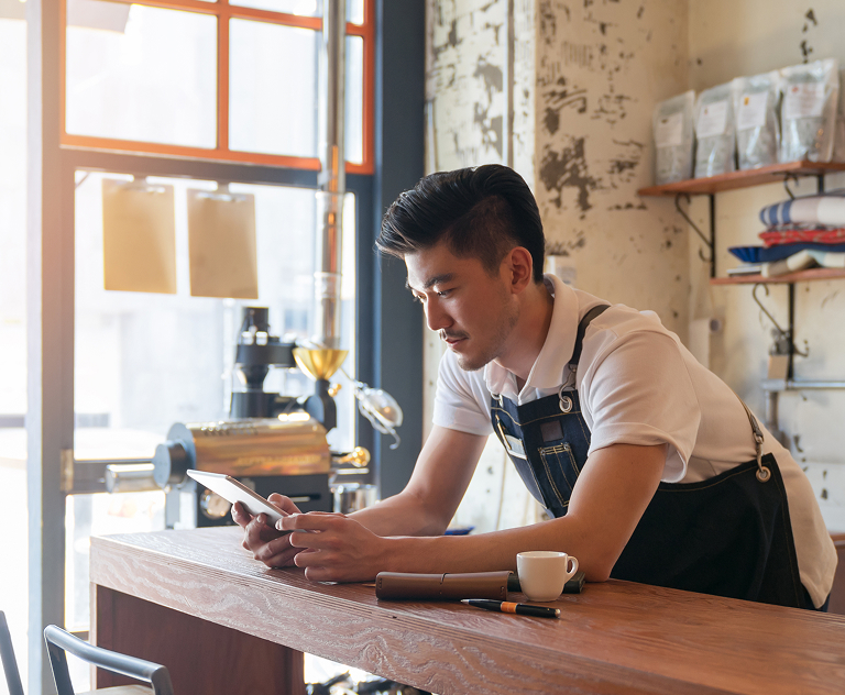 Barista using mobile phone