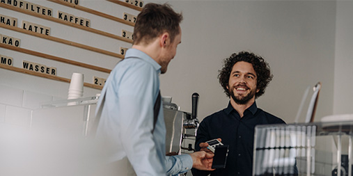 Man tapping eftpos across cafe counter