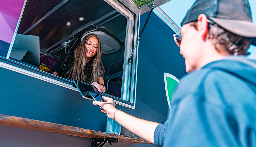 Woman in food truck receiving eftpos payment