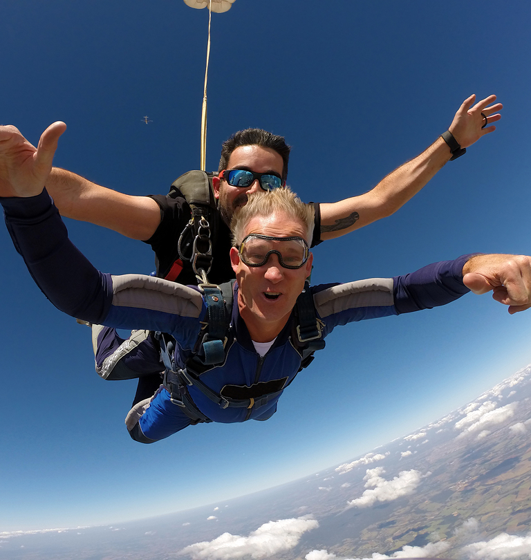 Man skydiving with instructor