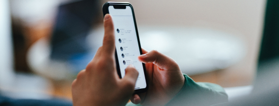 A man with a bald head is paddling on a blue surfboard in the ocean, enjoying the waves under a clear sky and living his life to the fullest.
