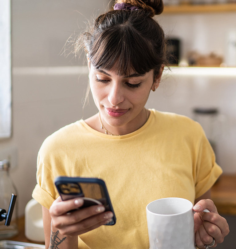 Woman with coffee and phone