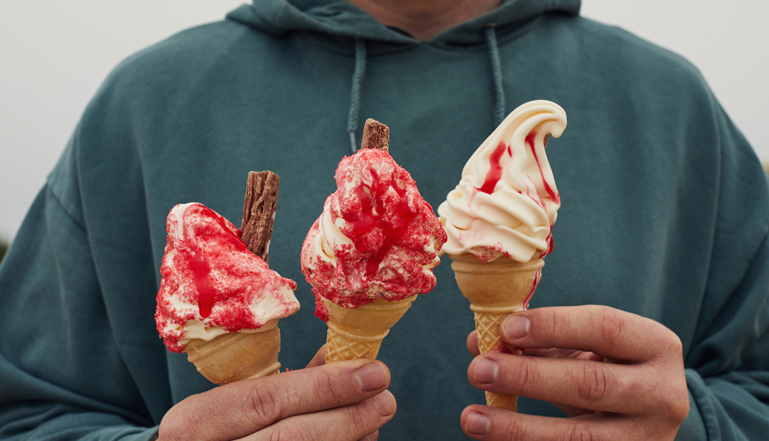 Hands holding three icecreams