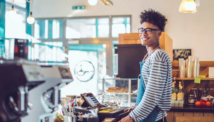 Man standing behind cafe counter