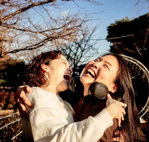 Two women hugging and laughing