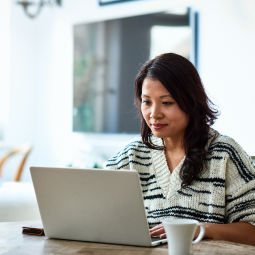 Woman with laptop and coffee mug