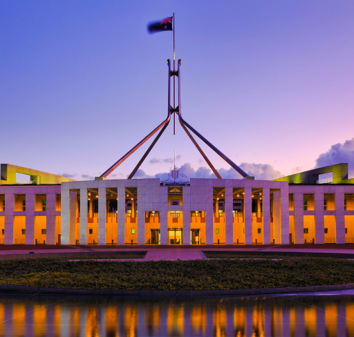 Australian Parliament House at dusk with flag flying