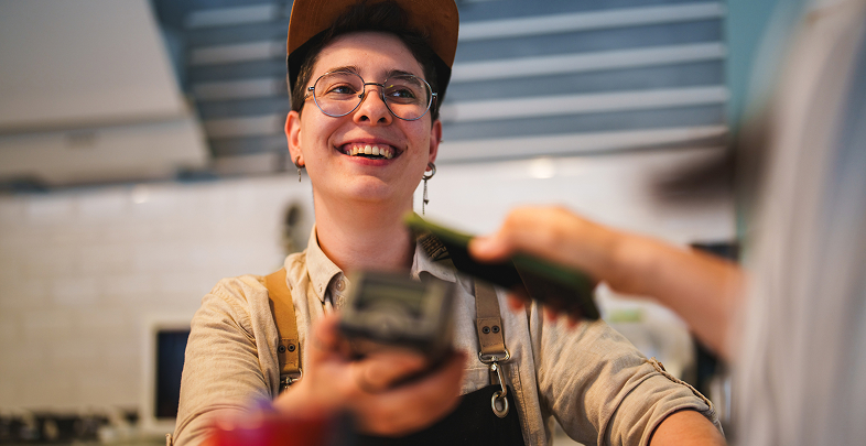 Person smiling holding eftpos machine