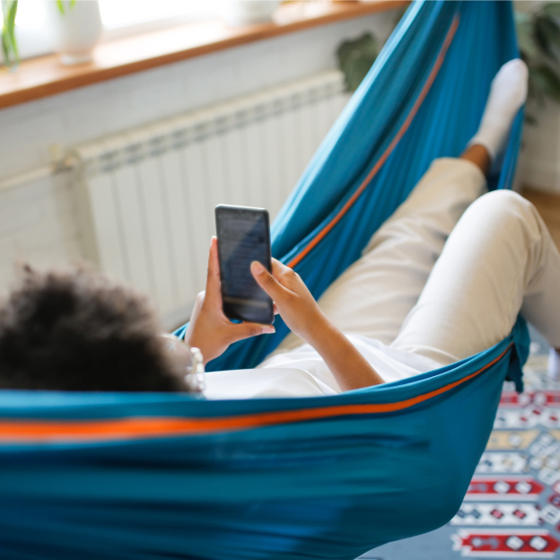 Relaxing in hammock with mobile phone