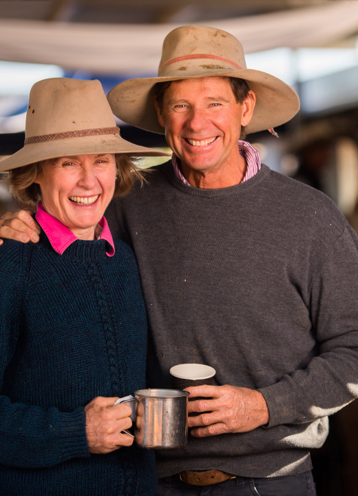 Rural couple holding camping mugs