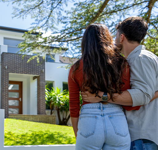 Couple-standing infront of house