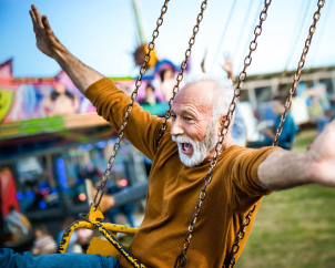 Older man enjoying fair ride