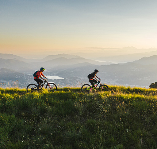 Two persons riding bicycle