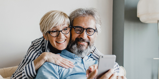 Old couple looking at phone