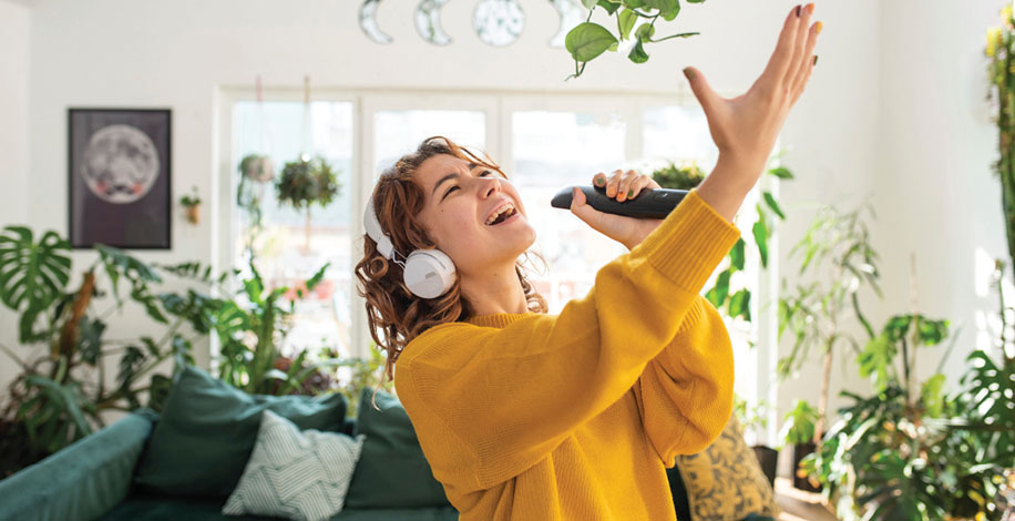 Woman singing with remote control