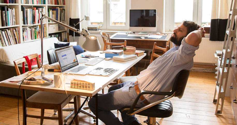 Man leaning back in desk chair